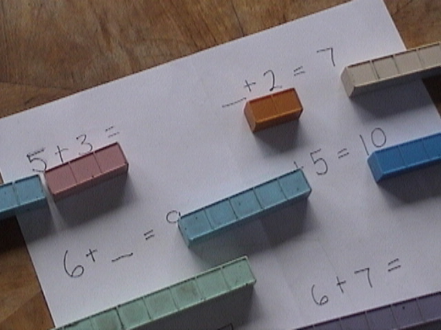addition blocks on white page close up